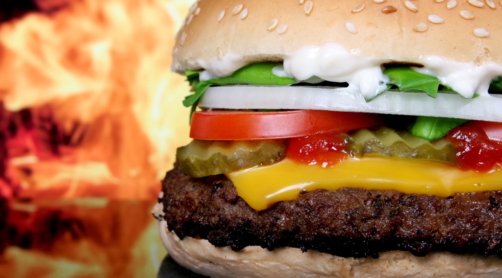 Silhouette of cheese burger and summer garden vegetables
